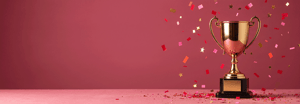 Trofeo dorato con coriandoli e stelle cadenti su sfondo rosa/bordeaux